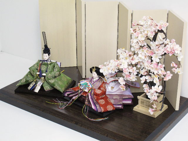 平安貴族の愛用した有職文様、鶴の丸を正絹衣装に織り込み着せ付けた落ち着いたお雛さまです。大きな桜の下に飾ります。