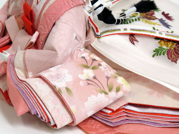 おとなしいピンクを使った桃色衣装雛を梅で囲った重厚な雛人形親王飾り